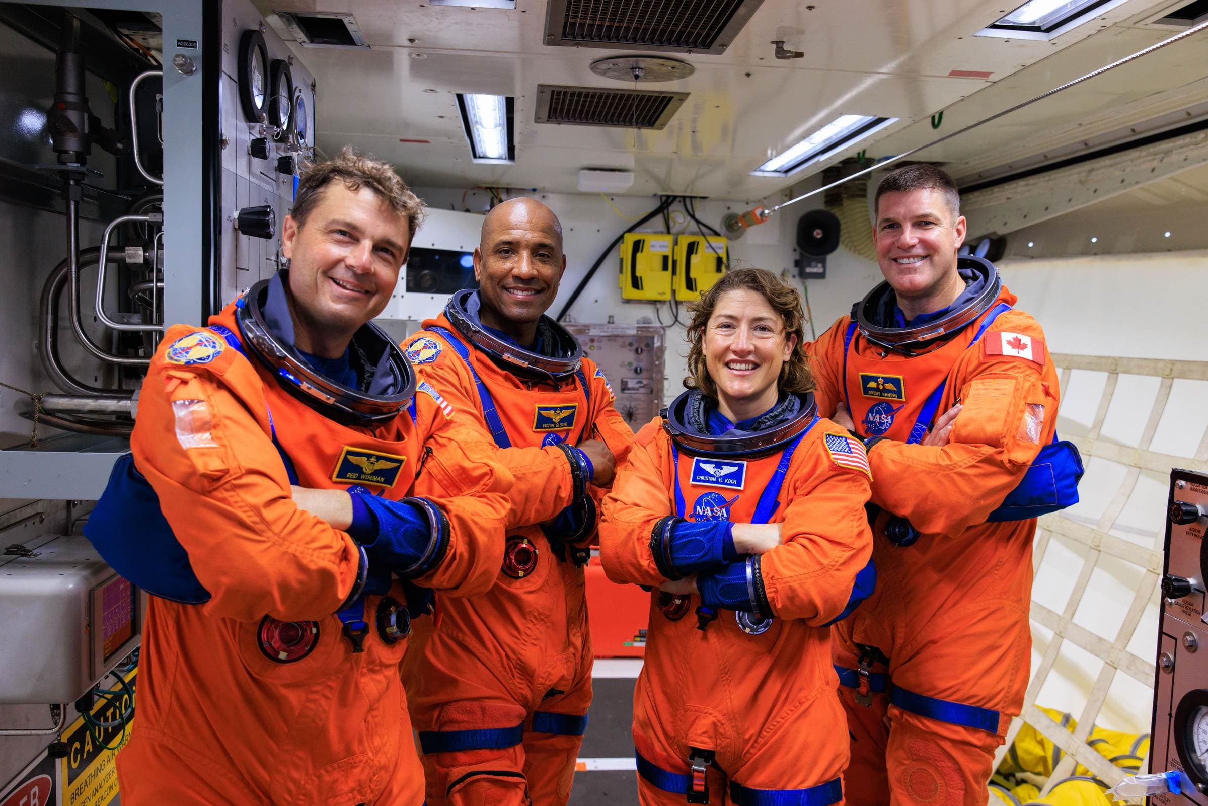 The Artemis II crew, Reid Wiseman, Victor Glover, Christina Koch and Jeremy Hansen, in orange flight suits