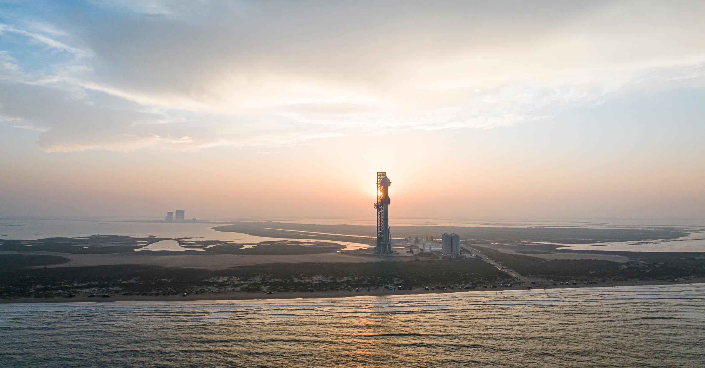 The Starbase launch tower on the Texas coast at sunset, seen from the sea